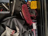 a suitcase filled with tools and other items on the floor