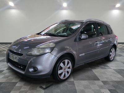 grey ford fiesta parked on a checkered tile floor in a garage