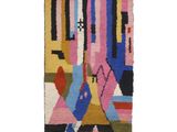 un tapis multicolore orné de motifs géométriques et de franges