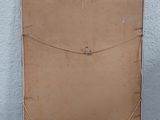 a brown piece of cardboard on the floor next to a white wall