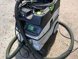 a machine that is sitting on the ground with a hose