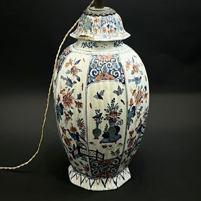 a white vase with a blue and red design on it