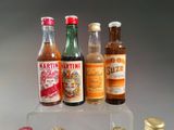 several bottles of alcohol are lined up on a clear shelf