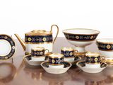 a table with a bunch of cups and saucers on it
