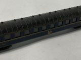 a black and blue train car sitting on a white surface
