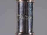 an antique silver plated wine bottle with a silver lid