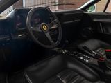 the interior of a black sports car with a steering wheel