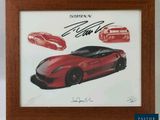signed autograph of a red sports car in a wooden frame