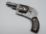 a gun that is sitting on a white surface