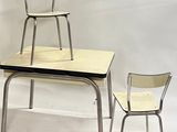 two chairs and a table with a chair on top of it