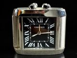 a silver and black watch with roman numerals on the face