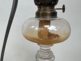 a glass lamp with a wooden handle on a table