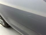 a close up of a car ' s door handle with a sticker on it