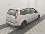 a picture of a small white car parked in a garage