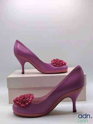purple high heeled shoes with flower decoration on the toe