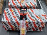 boxes of candy wrapped in plastic sitting on top of a conveyor belt