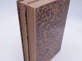a brown book that is sitting on a white surface