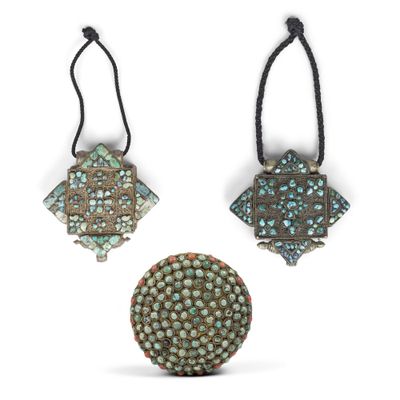 three pieces of metal with turquoise and brown designs on them