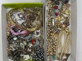 a box full of assorted jewelry sitting on a table