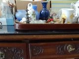 a wooden dresser with many items on top of it