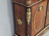 a marble top cabinet in the corner of a room