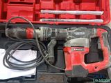 a drill in a case with tools inside of it