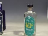 two bottles of alcohol sitting on a counter next to each other