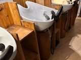 many sinks lined up in a row in the bathroom