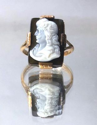 an image of a lady ' s ring with a carved cameo of a man ' s head
