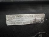 a close up of a metal plate on a car ' s engine