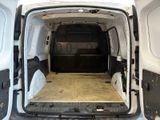 a white van with the door open in a garage