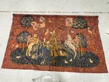 a tapestry with a picture of a man riding a horse