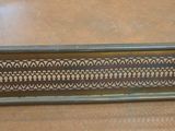 a metal plate with a design on it on a table