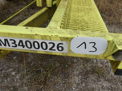 a close up of a yellow metal rail with a number on it