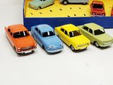 six toy cars in a blue box on a table
