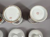 four cups and saucers are sitting on a white surface