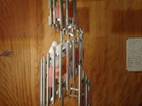 a sculpture of a tower made of knives on a wooden table