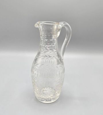 pichet en verre transparent orné d'un motif floral au fond