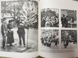 an open book with pictures of people and flags on it