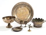 a lot of silver items that are sitting on a table