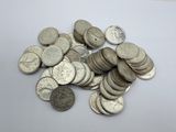 a pile of silver coins sitting on a table