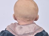 a small doll with a backpack on it ' s back