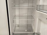 an empty refrigerator with its door open in a kitchen