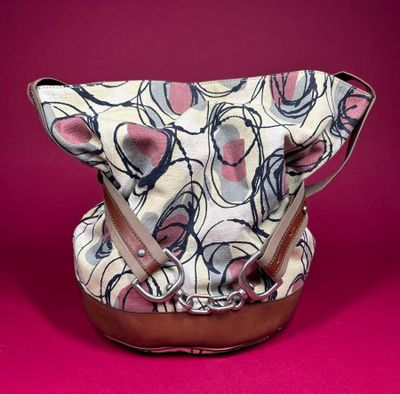 an image of a purse on a pink background