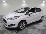 a white ford fiesta parked on a checkered tile floor