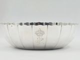 an image of a silver bowl sitting on top of a white table