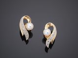 a pair of pearl and diamond earrings on a black surface