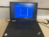 laptop with a blue screen sitting on top of a wooden table
