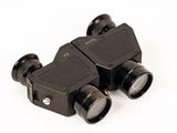a pair of binoculars sitting next to each other on a white surface