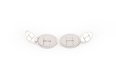 pair of silver stud earrings on white background